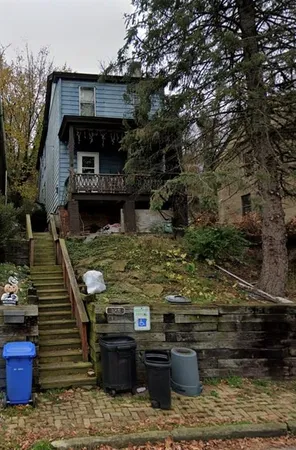 a front view of a house with chairs