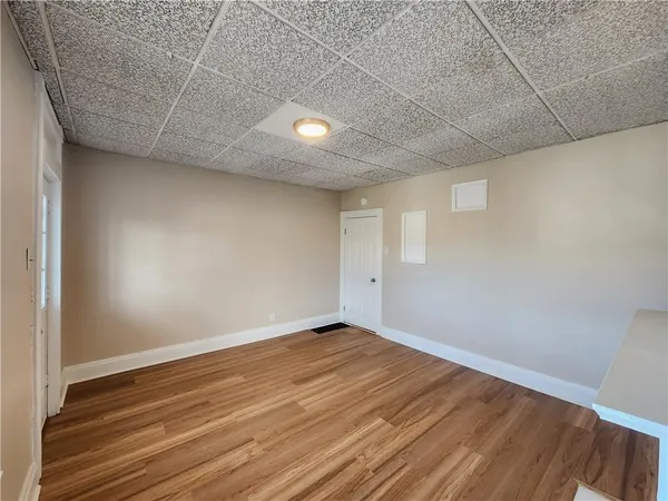 a view of room with wooden floor
