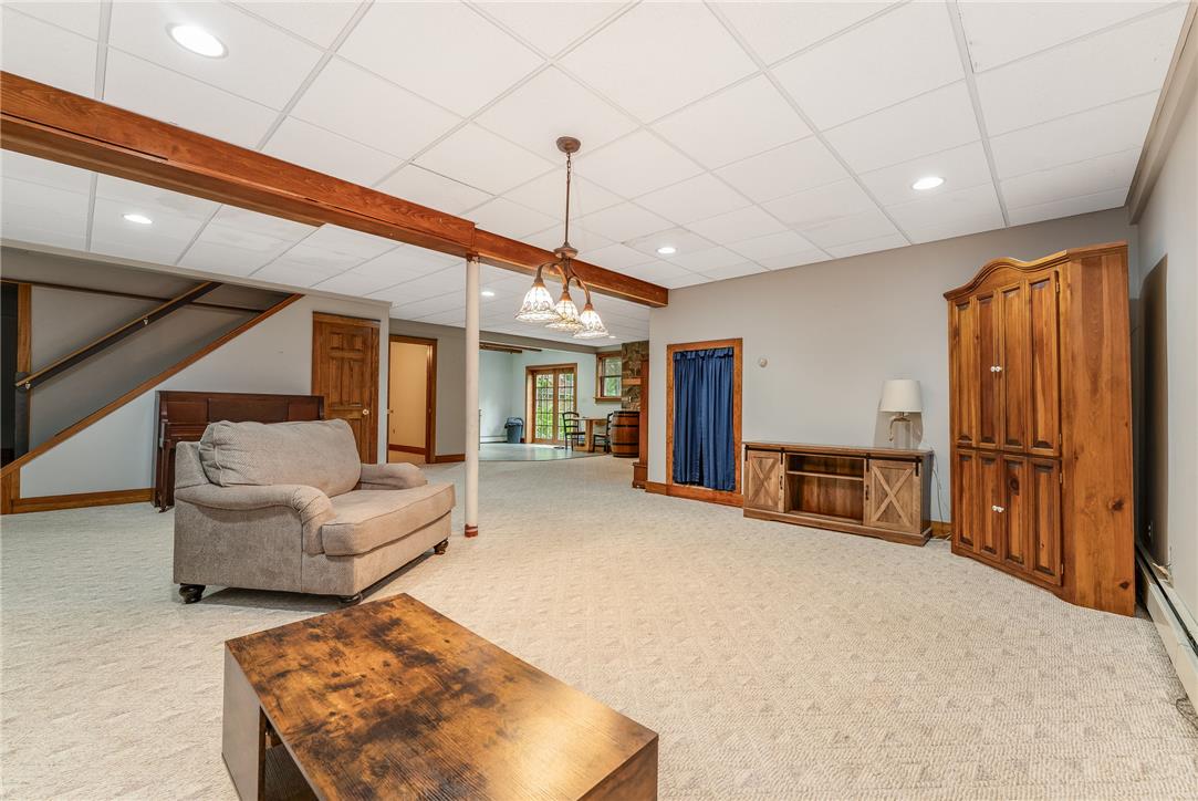 465 Raubsville Road Easton, PA 18042 - Photo 48 of 60 A generously proportioned recreational area with a soft carpeted floor and exposed wooden beams provides versatile living space.