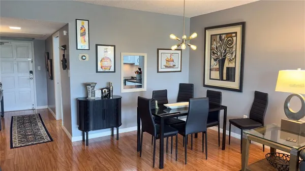 a view of a workspace with furniture and wooden floor