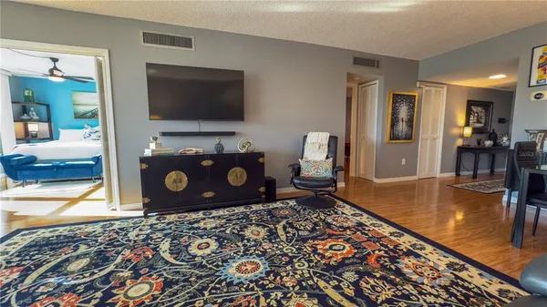 a living room with a gaming machine and a flat screen tv