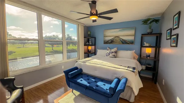 a bedroom with a bed a window and a chandelier
