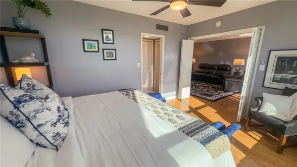 a bedroom with a bed and a flat tv screen on the dresser