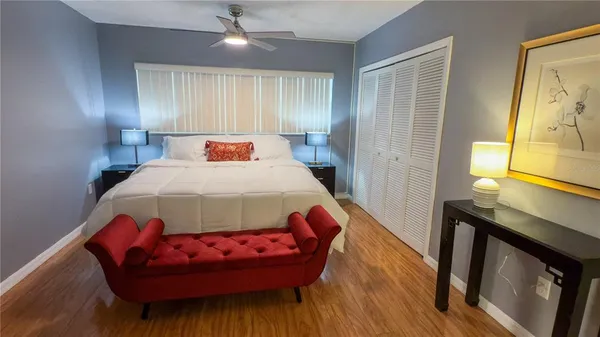 a bedroom with a bed and wooden floor