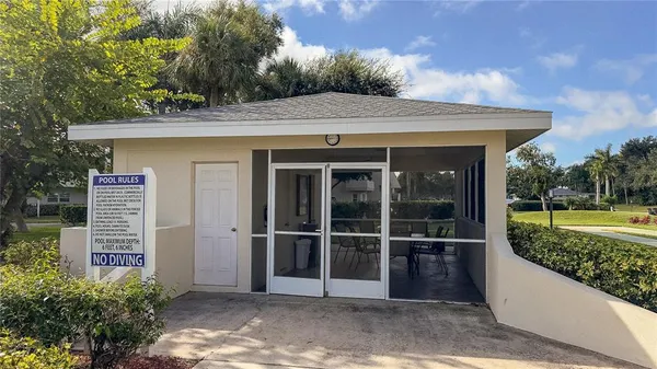 a view of a house with a large window and a yard