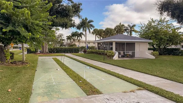 a view of house with swimming pool and green space