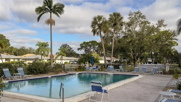 a view of swimming pool with a table and chairs