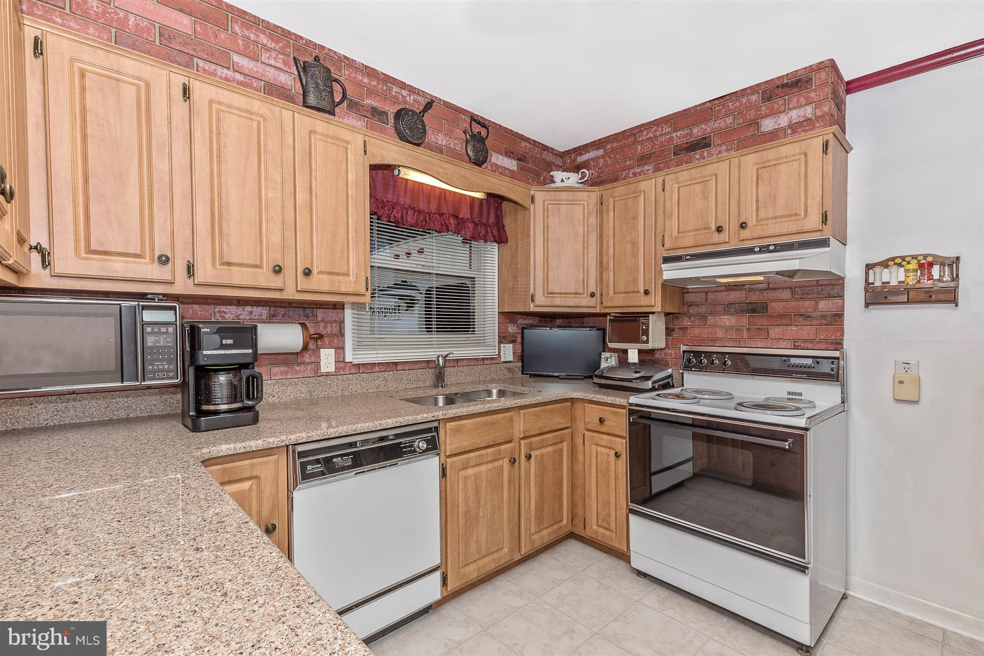 4406 Teen Barnes Road Frederick, MD 21703 - Photo 13 of 30 a kitchen with stainless steel appliances granite countertop a stove sink and cabinets