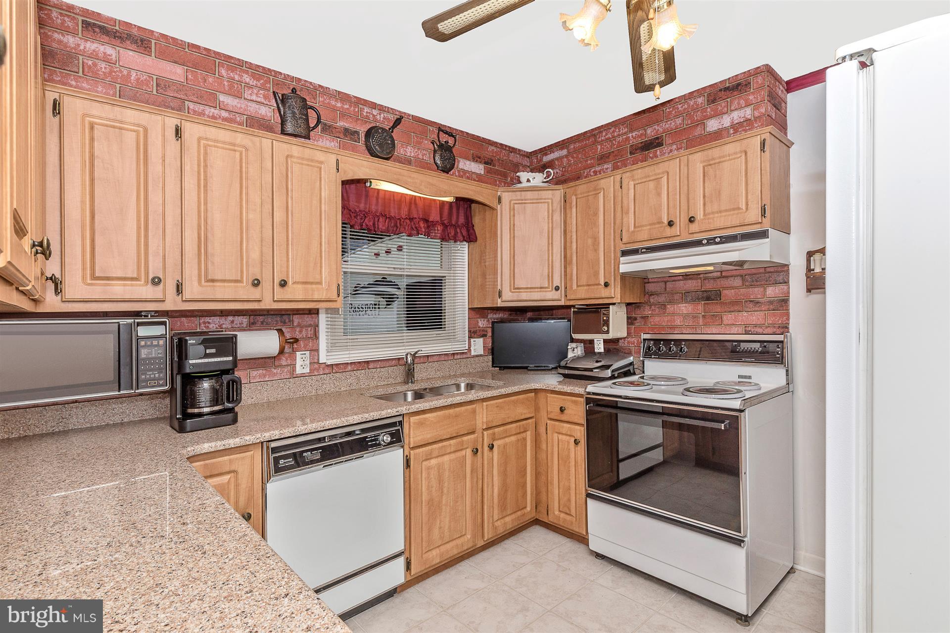 4406 Teen Barnes Road Frederick, MD 21703 - Photo 14 of 30 a kitchen with stainless steel appliances granite countertop a stove a sink and a microwave