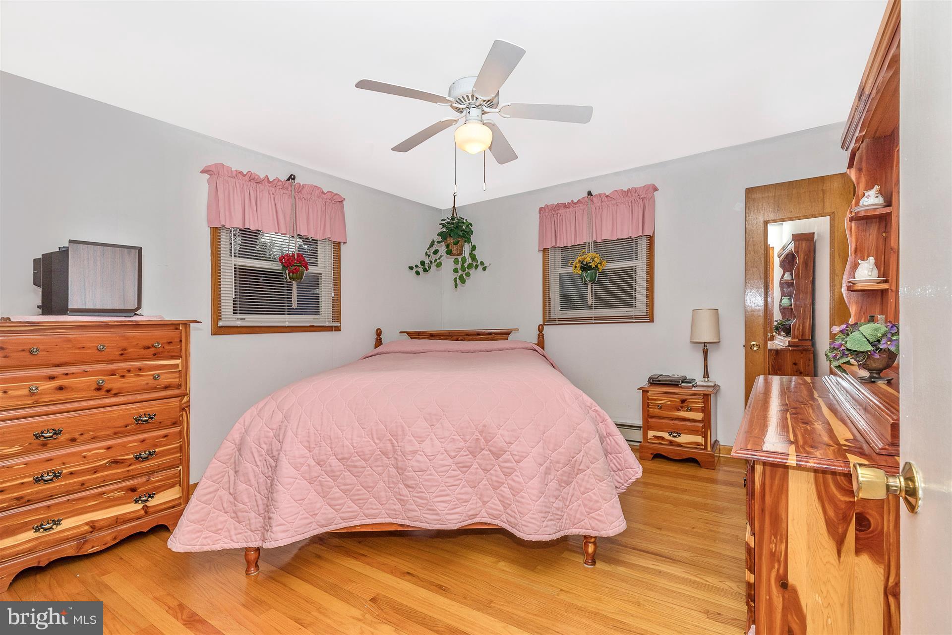 4406 Teen Barnes Road Frederick, MD 21703 - Photo 17 of 30 a bedroom with a bed and a chandelier