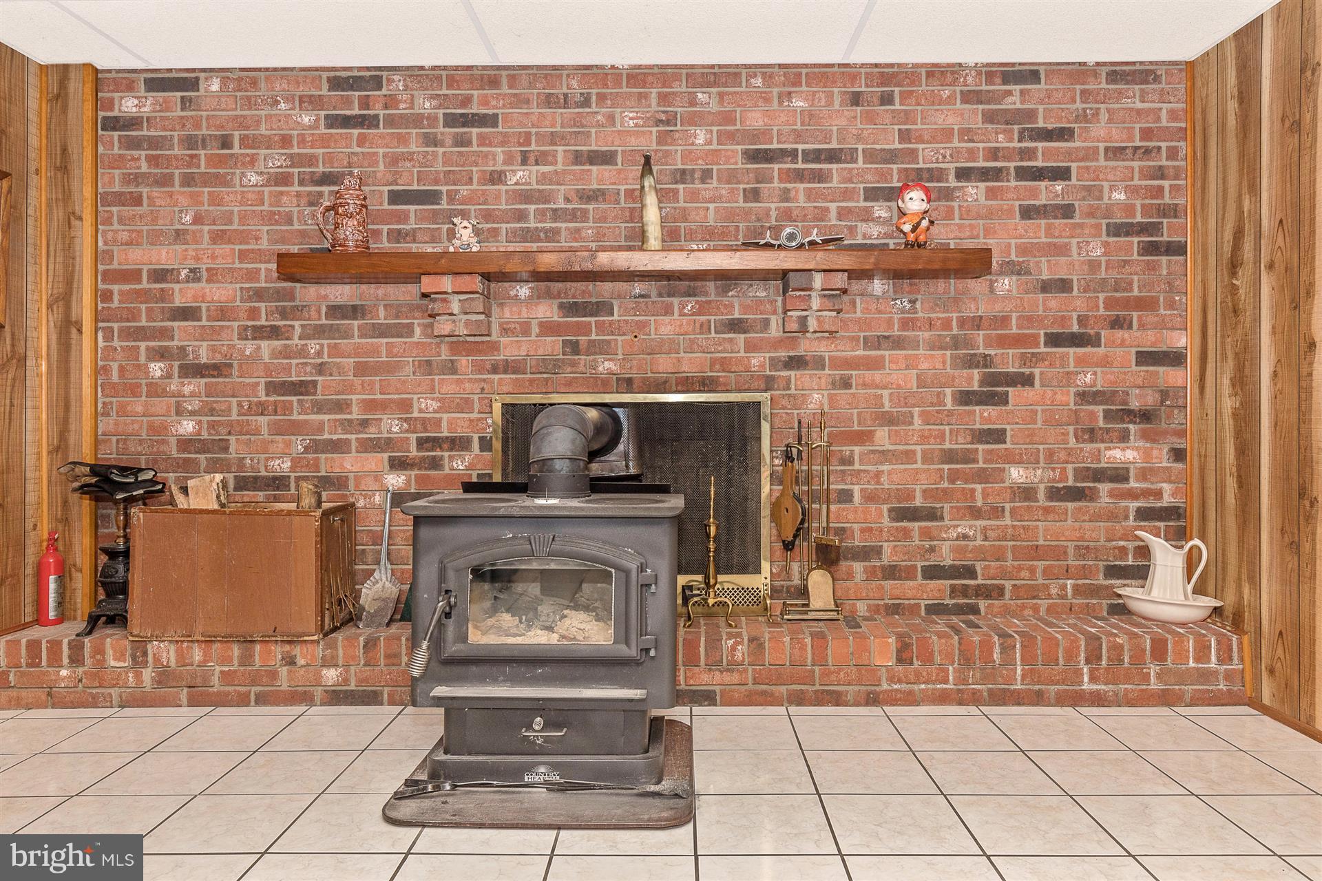 4406 Teen Barnes Road Frederick, MD 21703 - Photo 22 of 30 a living room with a brick wall and a fireplace
