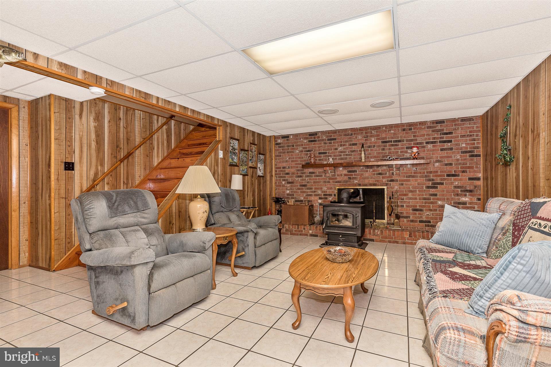 4406 Teen Barnes Road Frederick, MD 21703 - Photo 23 of 30 a living room with furniture a fireplace and a table