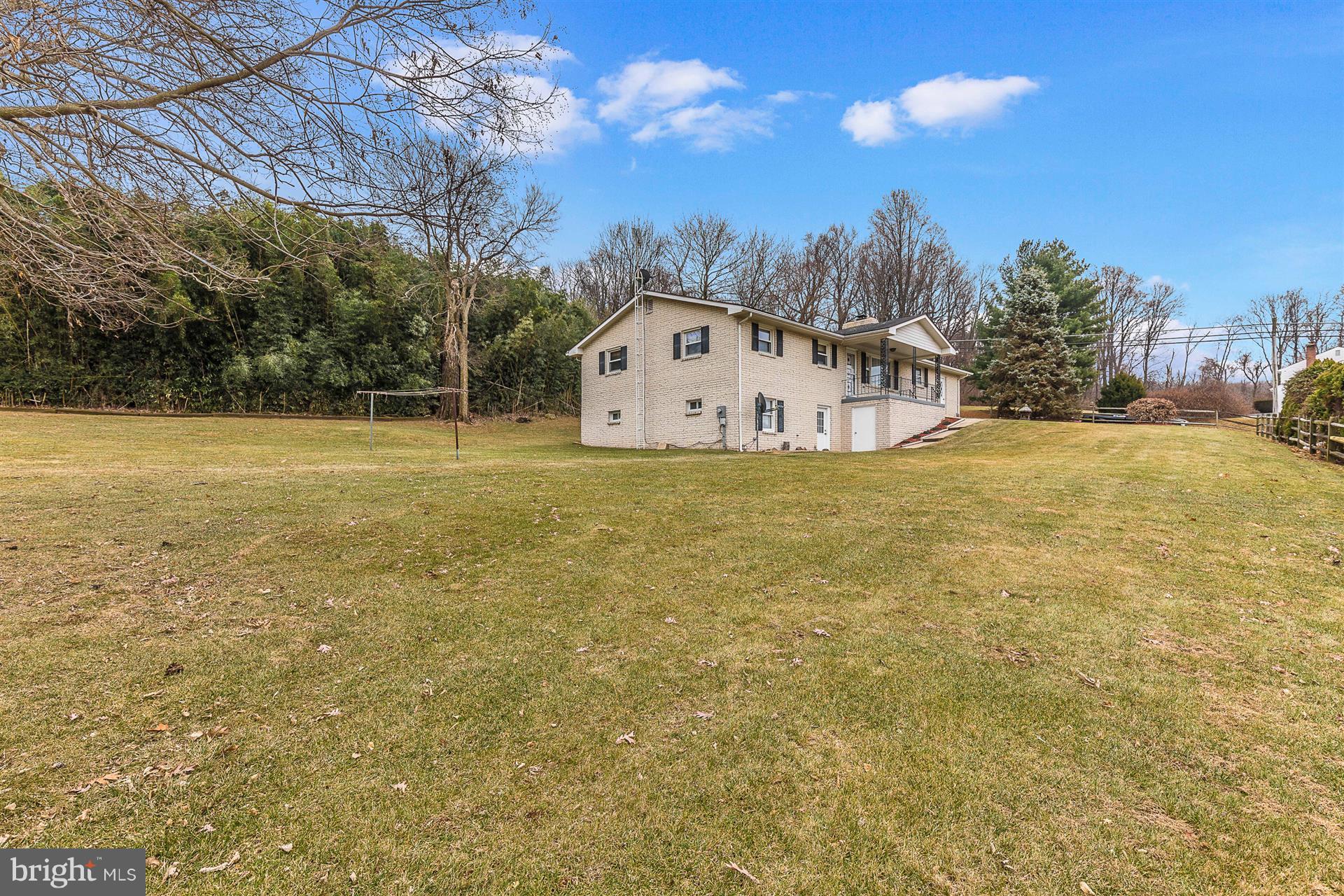 4406 Teen Barnes Road Frederick, MD 21703 - Photo 4 of 30 a large house with a big yard and large trees