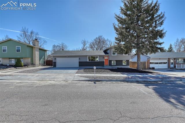1913 Wooten Road Colorado Springs, CO 80915 - Photo 6 of 50 Split level home featuring a garage