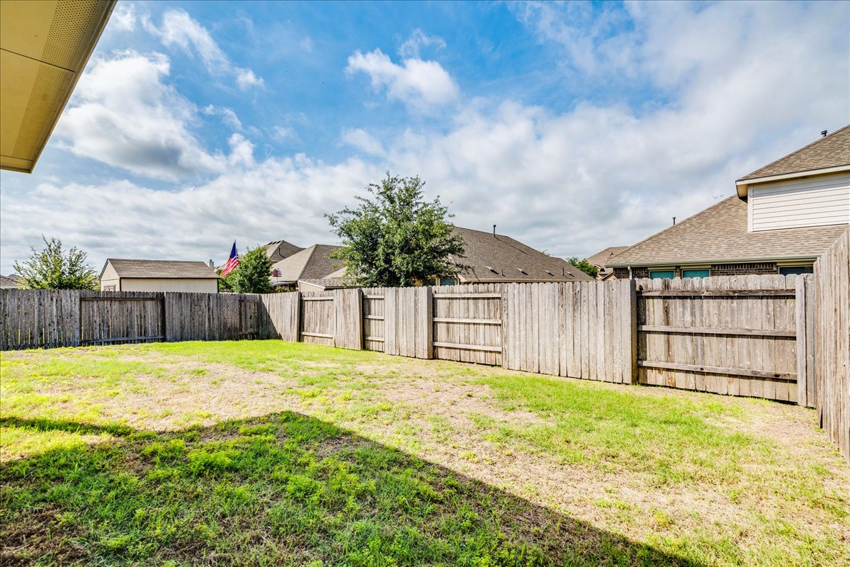 124 Compass Lane Kyle, TX 78640 - Photo 31 of 38 a view of a backyard with a small cabin
