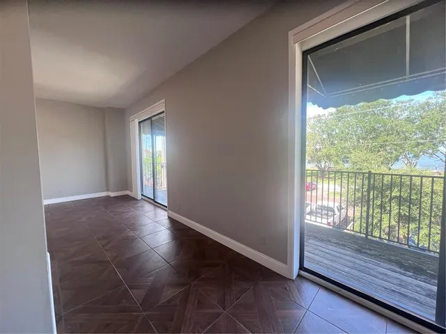 a view of wooden floor and windows in an empty room