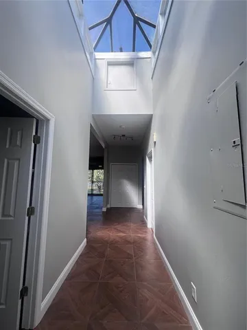 a view of a hallway with wooden shelves