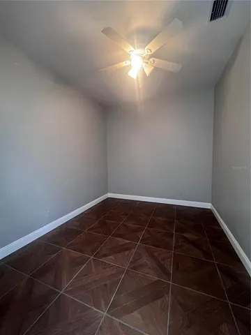 a view of a room with wooden floor and windows