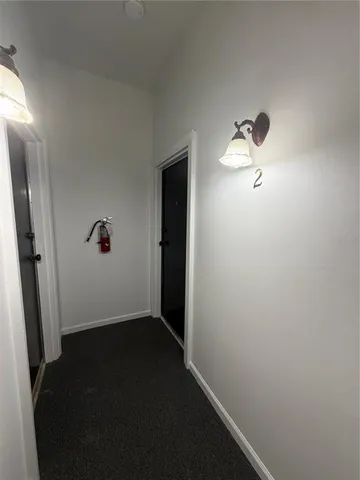 an empty room with wooden floor and mirror