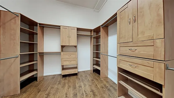 a view of walk in closet with empty racks
