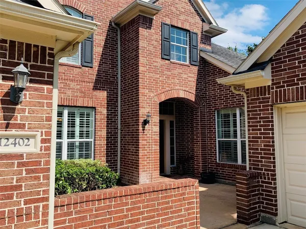 a view of a brick house with large windows