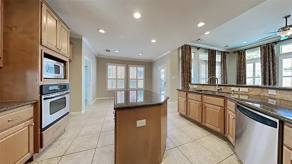 a kitchen with stainless steel appliances granite countertop a stove and a sink