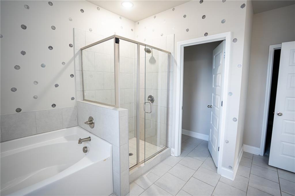 2215 Manor Pointe Drive Cumming, GA 30041 - Photo 13 of 25 a bathroom with a bathtub and a shower