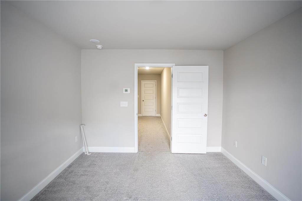 2215 Manor Pointe Drive Cumming, GA 30041 - Photo 23 of 25 an empty room with a natural light