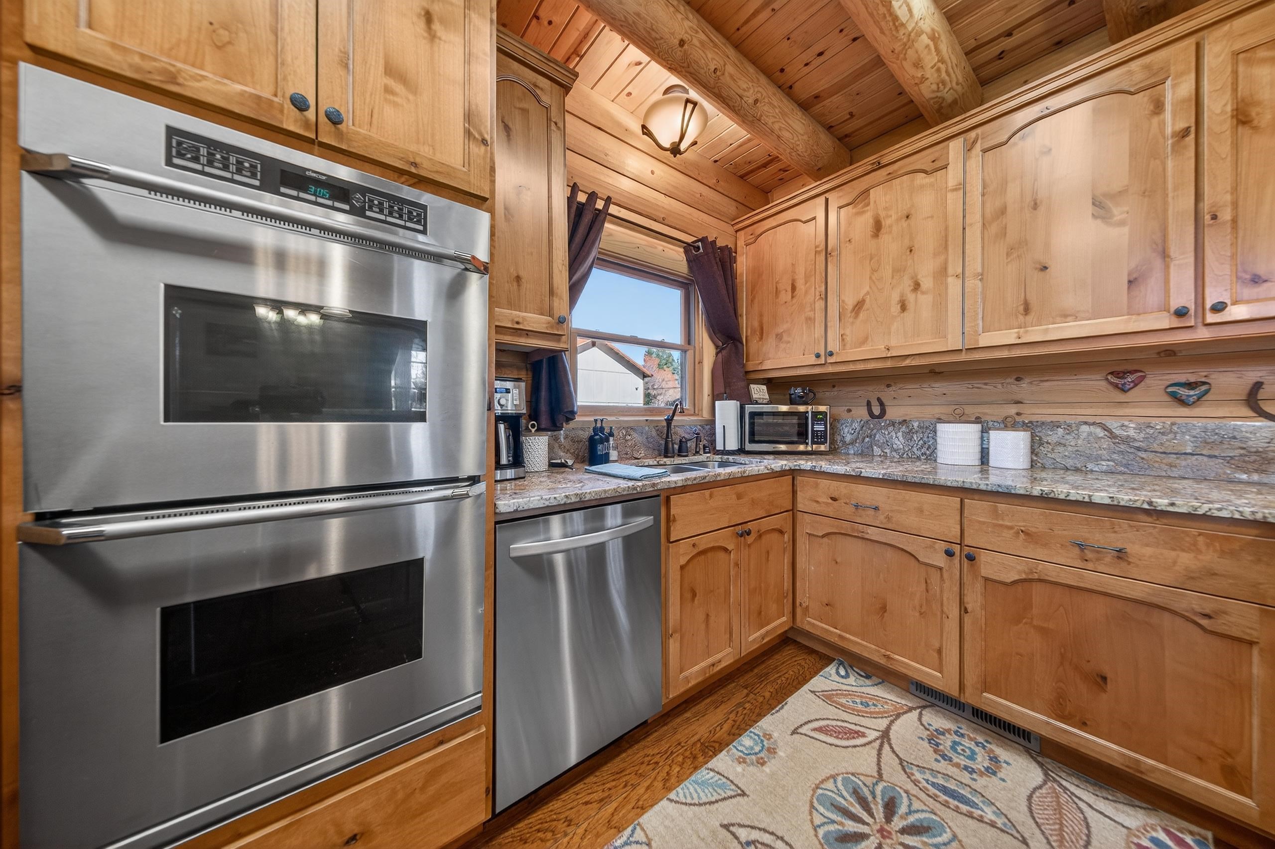 645 Main Street Chester, CA 96020 - Photo 7 of 43 a kitchen with stainless steel appliances granite countertop a stove and a microwave