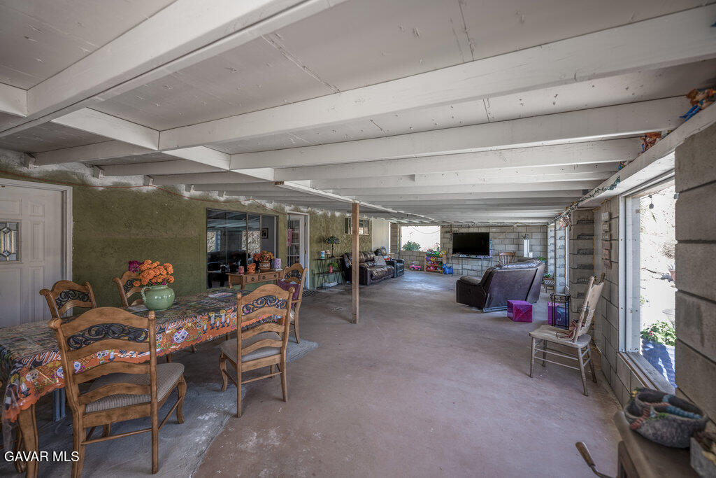 9555 Hierba Road Agua Dulce, CA 91390 - Photo 17 of 19 a living room with lots of furniture and a flat screen tv