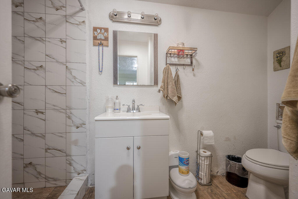 9555 Hierba Road Agua Dulce, CA 91390 - Photo 4 of 19 a bathroom with a sink a toilet and mirror