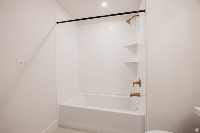 5902 Canyon Rim Road, Unit 620 Lehi, UT 84048 - Photo 64 of 78 Bathtub and shower combination featuring white subway tile surround, bronze-finish fixtures, and integrated corner shelving
