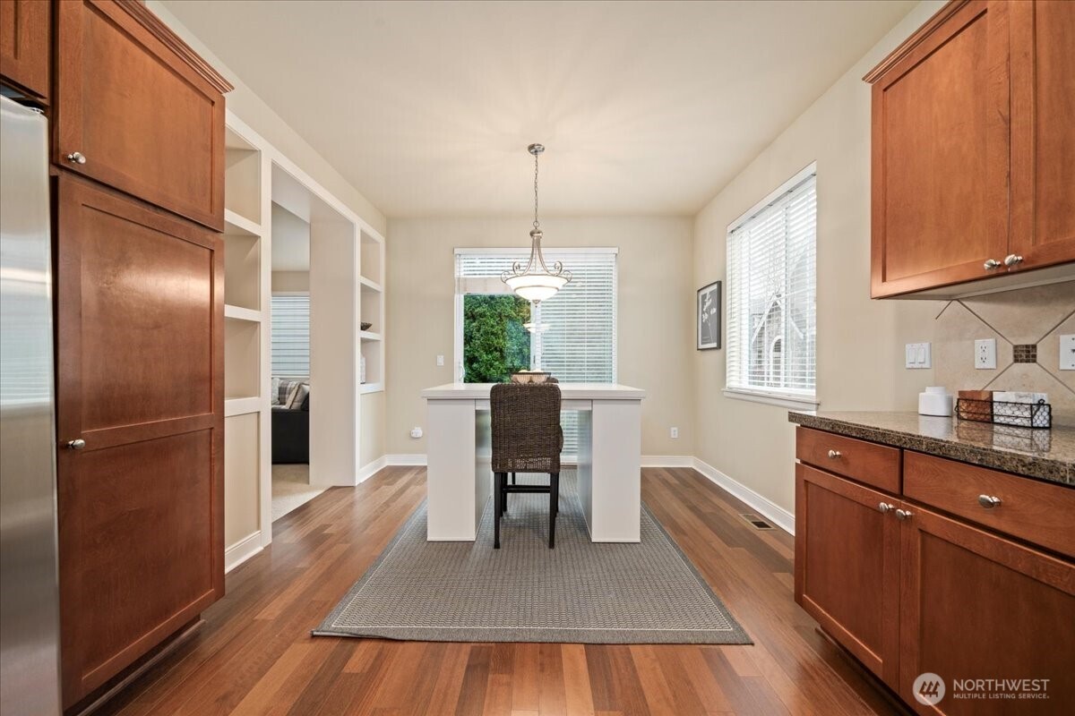 18213 36th Avenue Southeast Bothell, WA 98012 - Photo 11 of 34 a kitchen with kitchen island a counter top space wooden floor and stainless steel appliances