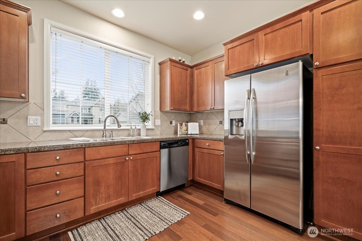 18213 36th Avenue Southeast Bothell, WA 98012 - Photo 12 of 34 a kitchen with stainless steel appliances granite countertop a refrigerator and a sink
