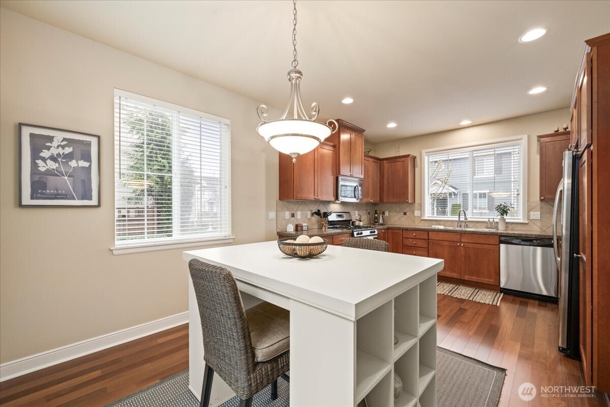 18213 36th Avenue Southeast Bothell, WA 98012 - Photo 13 of 34 a kitchen with a sink a stove a dining table and chairs