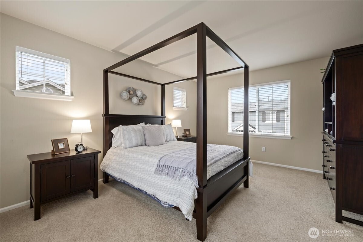 18213 36th Avenue Southeast Bothell, WA 98012 - Photo 16 of 34 a large bed sitting in a bedroom next to a window