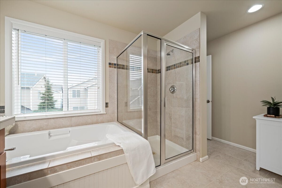 18213 36th Avenue Southeast Bothell, WA 98012 - Photo 18 of 34 a bathroom with a bathtub and a shower