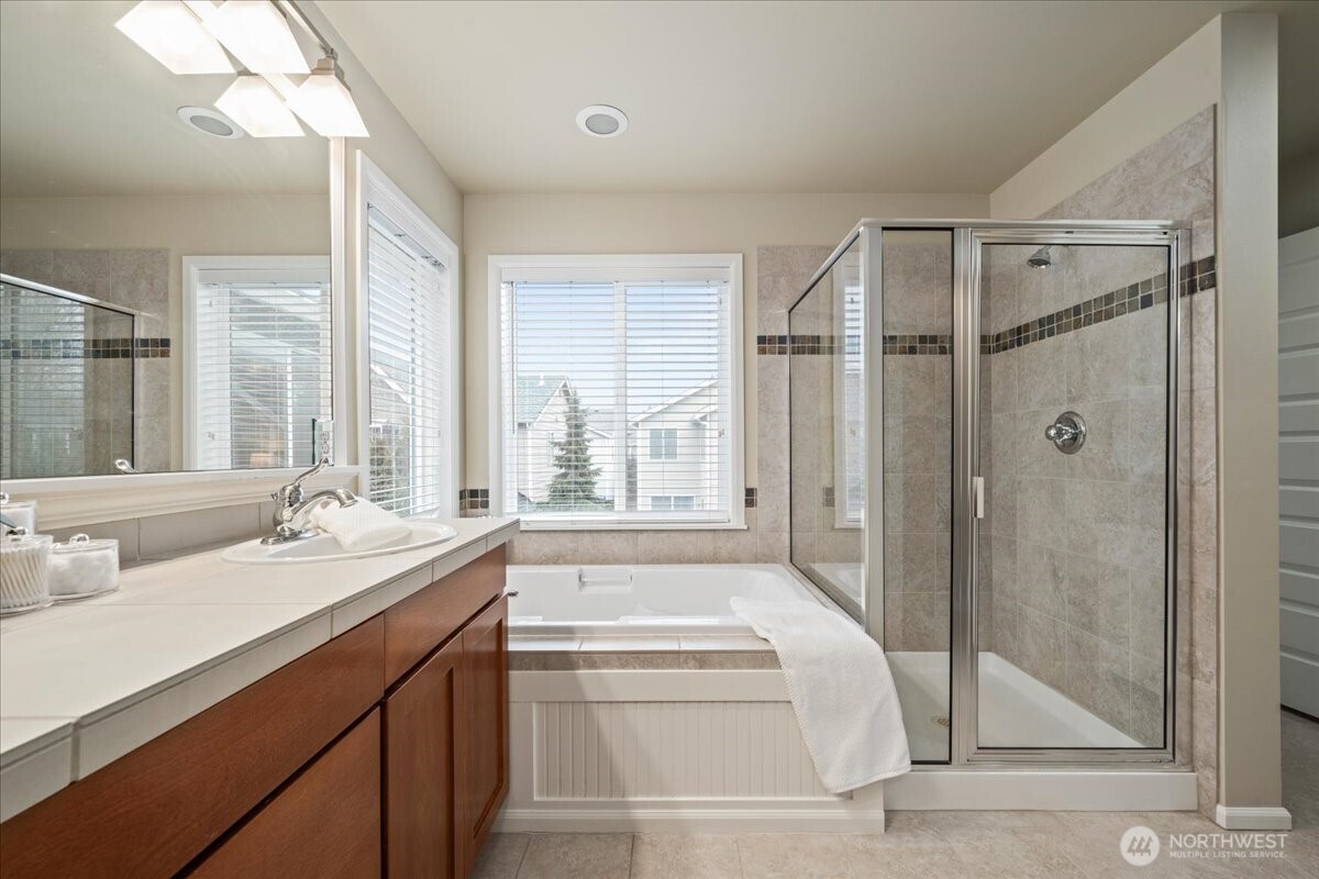 18213 36th Avenue Southeast Bothell, WA 98012 - Photo 19 of 34 a bathroom with a tub sink and mirror