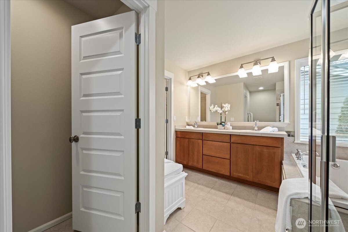 18213 36th Avenue Southeast Bothell, WA 98012 - Photo 20 of 34 a bathroom with a granite countertop sink mirror and