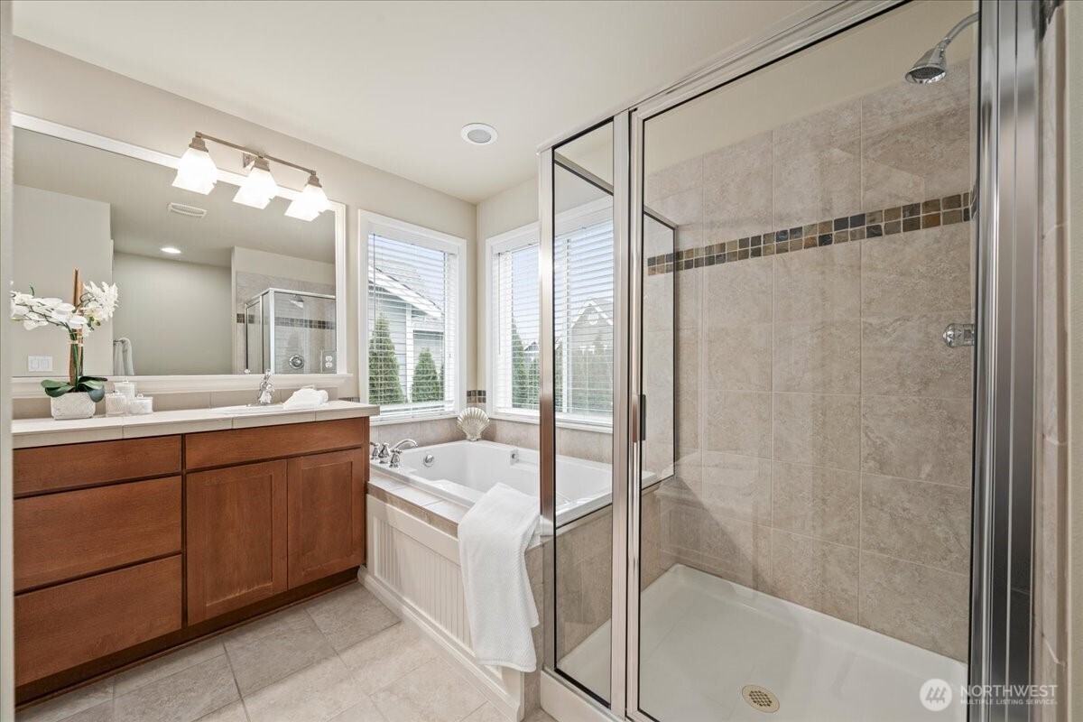 18213 36th Avenue Southeast Bothell, WA 98012 - Photo 21 of 34 a bathroom with a tub sink shower and mirror