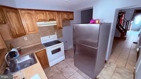 a kitchen with granite countertop a stove and a refrigerator