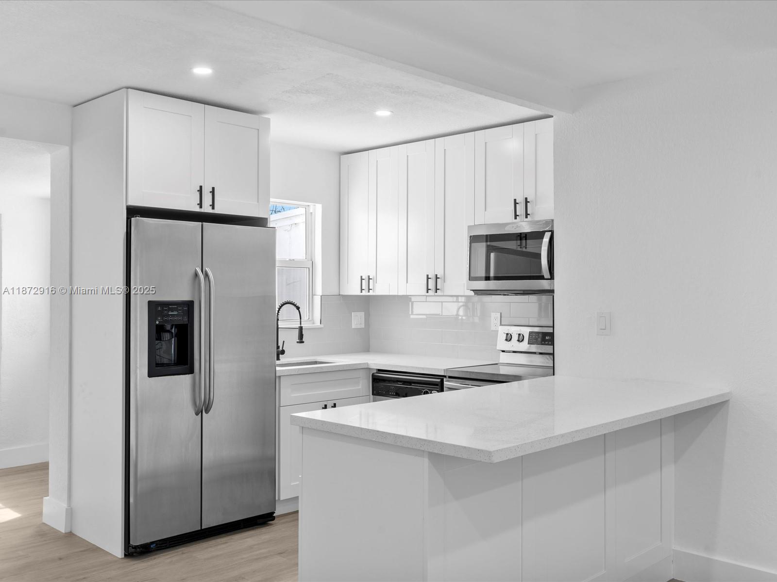 5365 Southwest 97th Court Miami, FL 33165 - Photo 14 of 51 a kitchen with stainless steel appliances a refrigerator sink and microwave