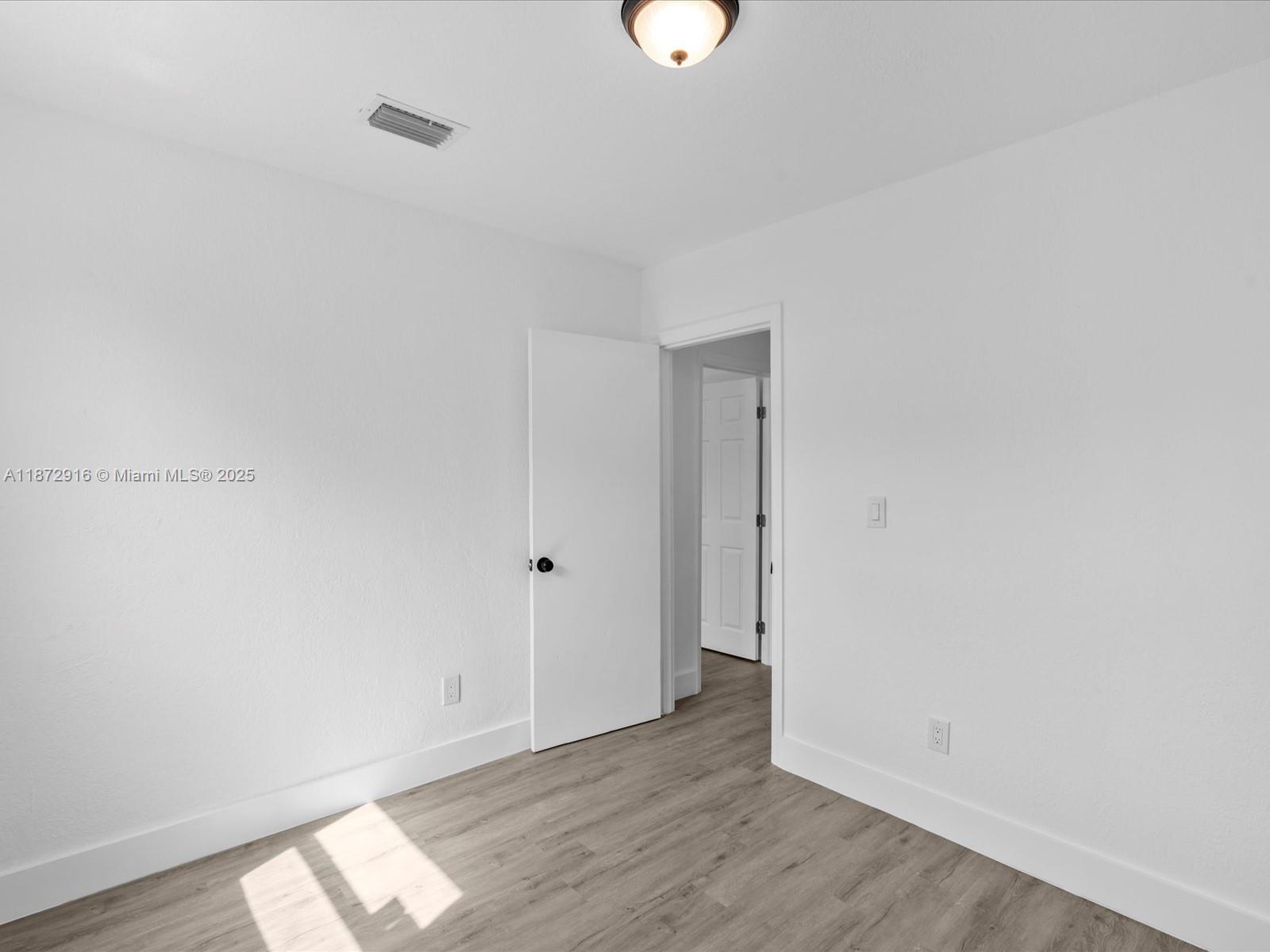 5365 Southwest 97th Court Miami, FL 33165 - Photo 29 of 51 a view of room with wooden floor