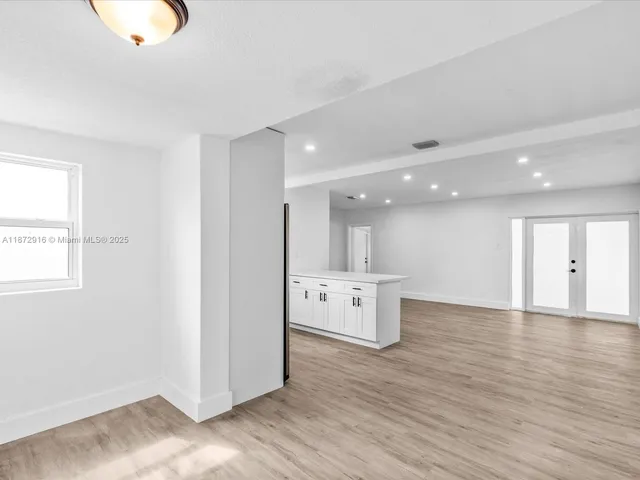 a view of a kitchen with wooden floor