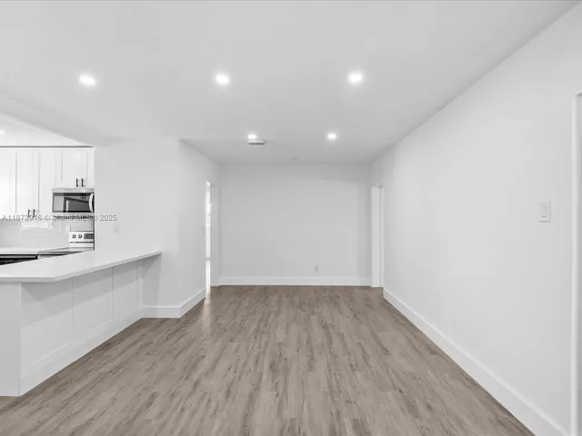 a view of kitchen with sink and wooden floor