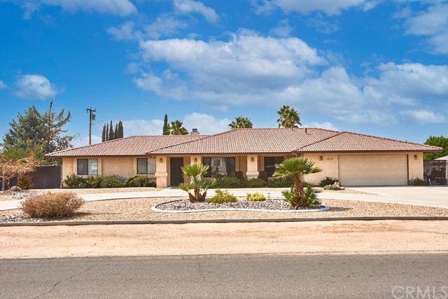 14004 Crow Road Apple Valley, CA 92307 - Photo 1 of 1 a front view of a house with a yard