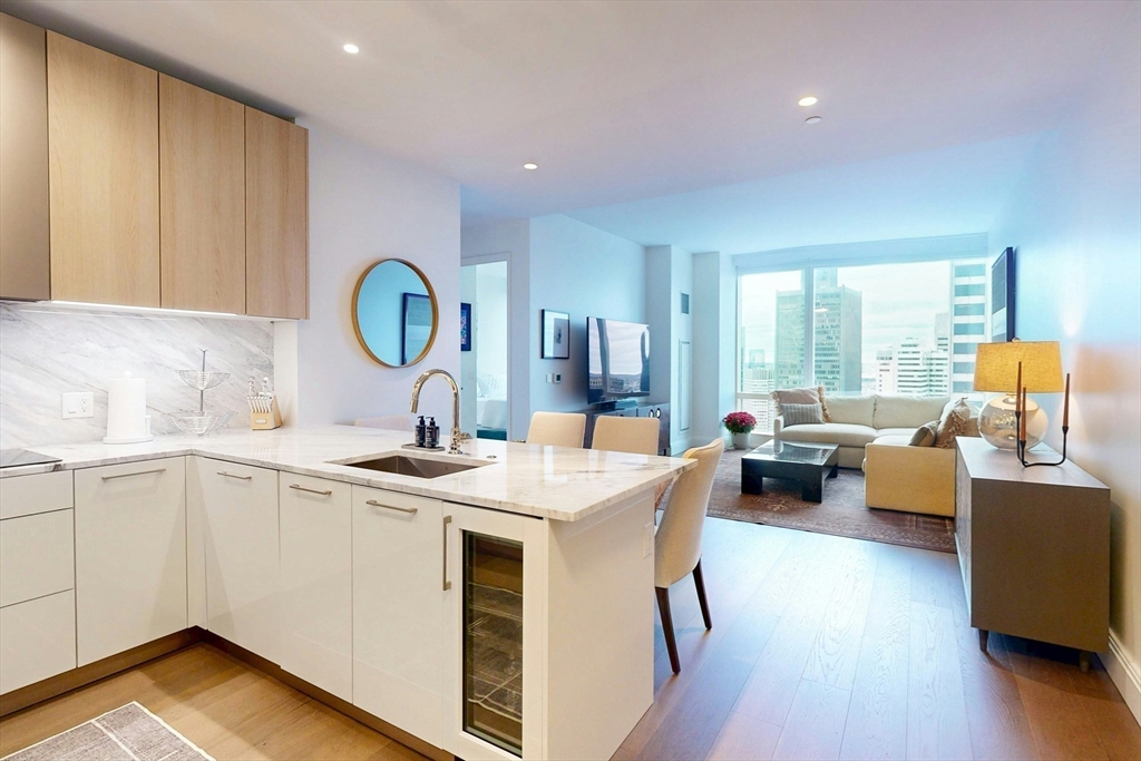 240 Devonshire Street, Unit U3814 Boston, MA 02110 - Photo 3 of 40 a open kitchen with a sink and dishwasher with wooden floor