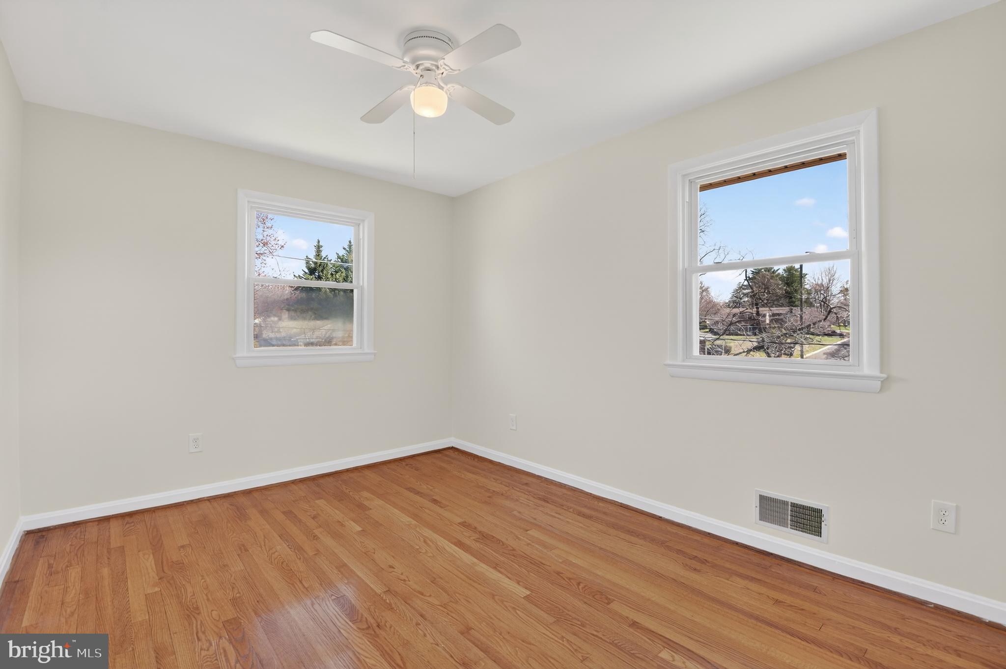 11004 Oakwood Street Silver Spring, MD 20901 - Photo 21 of 35 a view of empty room with wooden floor and fan