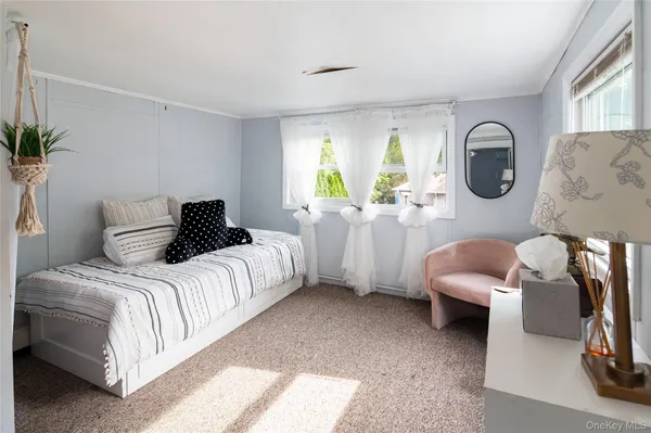 a bedroom with bed and a large window