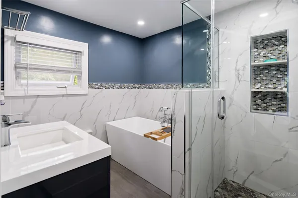 a bathroom with a sink a toilet a shower and a mirror